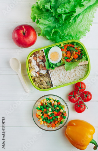 Top view of lunch box on light wooden background
