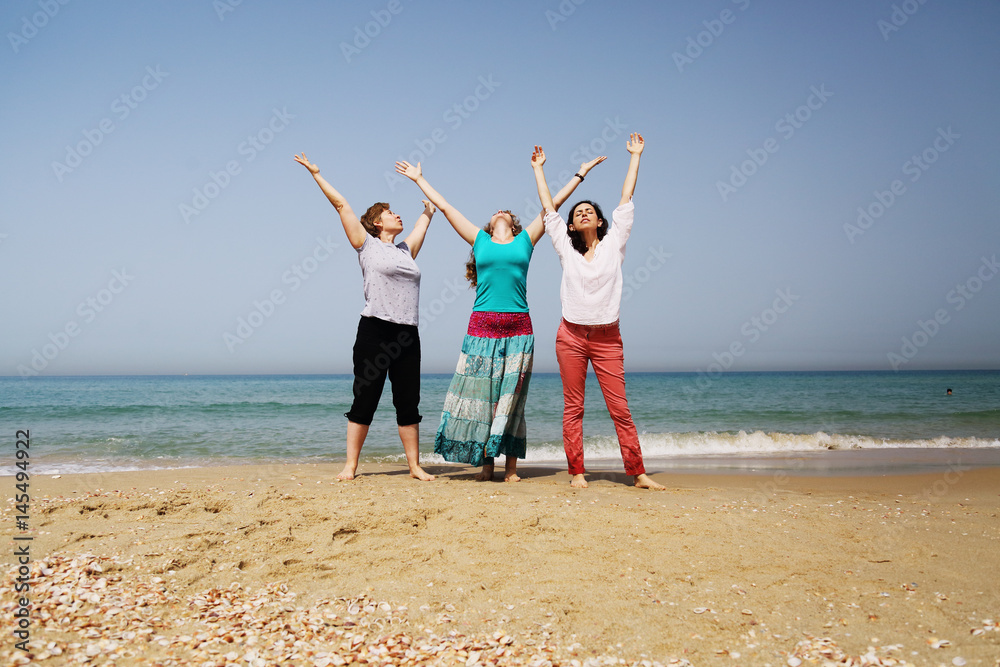 Portrait of three 40 years old women on seaside