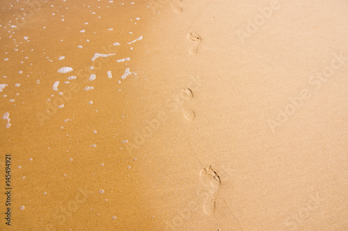 Footprints of a person walking on sand