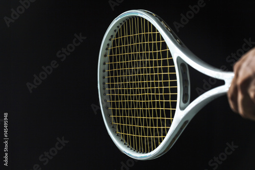 Tennis racket on black background