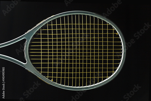 Tennis racket on black background © Naypong Studio