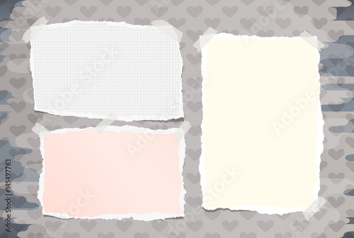 Ripped colorful, white notebook, copybook note paper stuck with sticky tape on pattern created of heart shapes