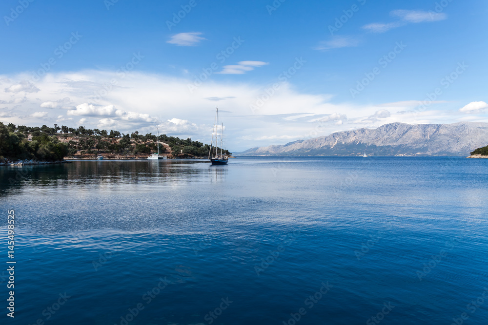Sailing boat in the beautiful blue lagoon. Yachting in Ionian Sea, Lefkada Island, Greece