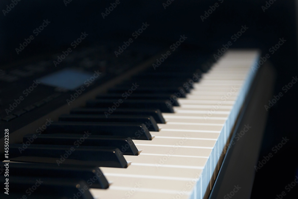 Synthesizer on a black background close up. Detail, selective focus. Synthesizer on a black background close up. Detail, selective focus.