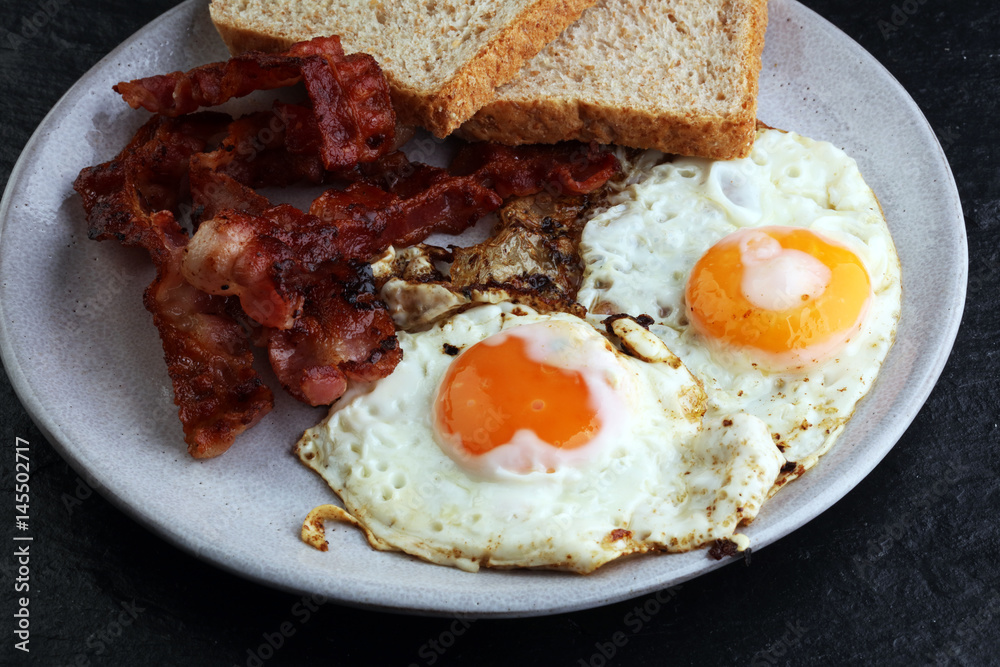Ham and Egg. Bacon and Egg. Salted egg and sprinkled with black pepper. English breakfast. Ham and Egg. Bacon and Egg. Salted egg and sprinkled with black pepper. English breakfast.