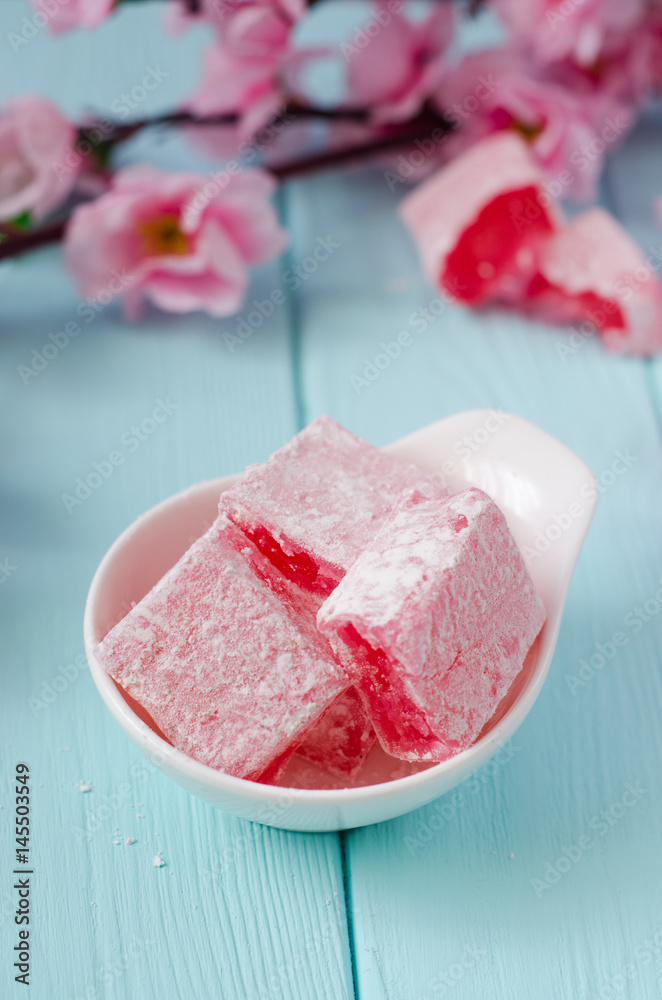 Rose flavored rahat lokum Turkish delight on wooden background. Selective focus. Ramadan food Rose flavored rahat lokum Turkish delight on wooden background. Selective focus. Ramadan food