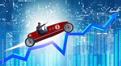 Businessman riding sports car against charts photo