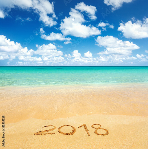 2018 written on sandy beach photo