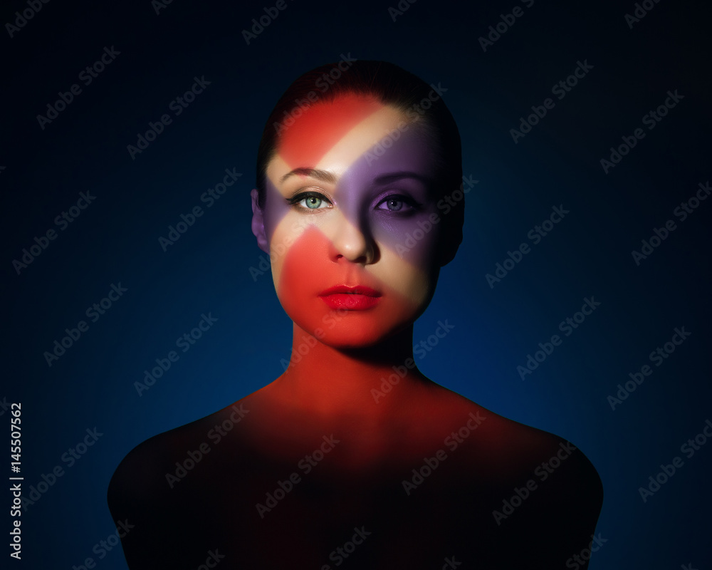 Fashion art portrait of elegant naked young woman with color light on her face Fashion art portrait of elegant naked young woman with color light on her face