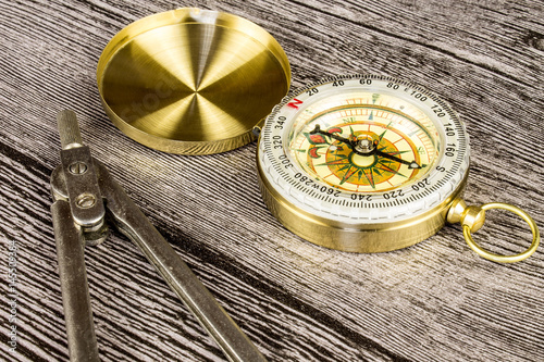 tourist compas and circinus on wooden table photo