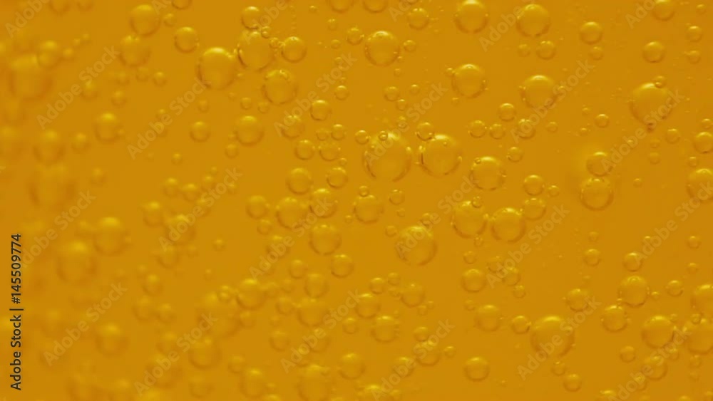 Fizzy soft orange drink bubbles floating macro slow motion 720p