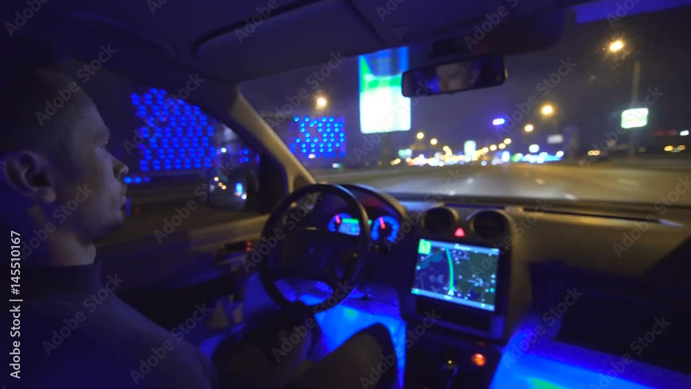 The man drive a car on the city highway. evening night time. inside view, real time capture The man drive a car on the city highway. evening night time. inside view, real time capture