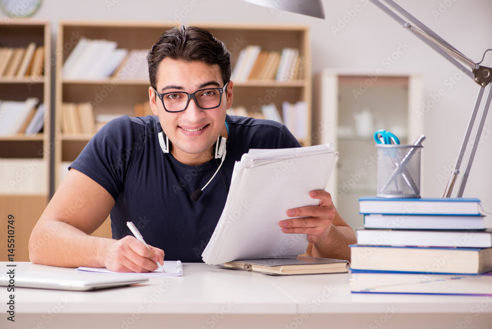 Happy male student preparing for his exams Happy male student preparing for his exams