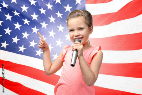 Cuadro en lienzo Cute little girl with microphone on white background