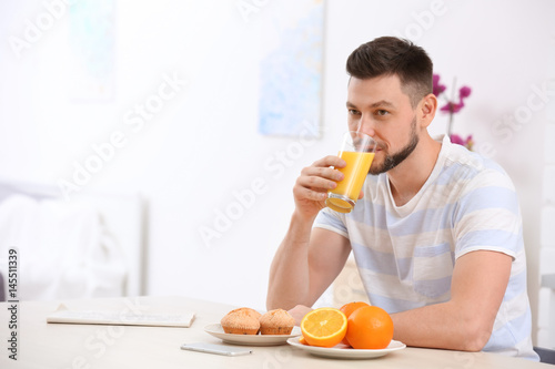 Handsome man with juice at home