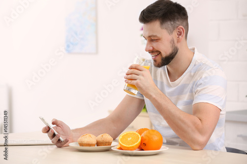 Handsome man with juice at ...