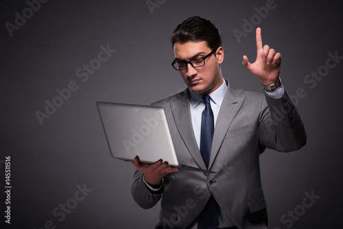 Handsome businessman working on laptop computer