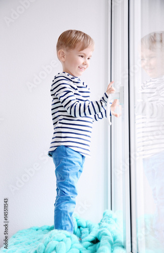 Cute little boy standing on...
