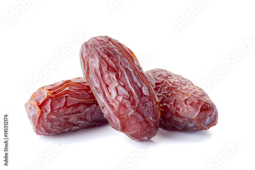 Three dried date-fruit on white