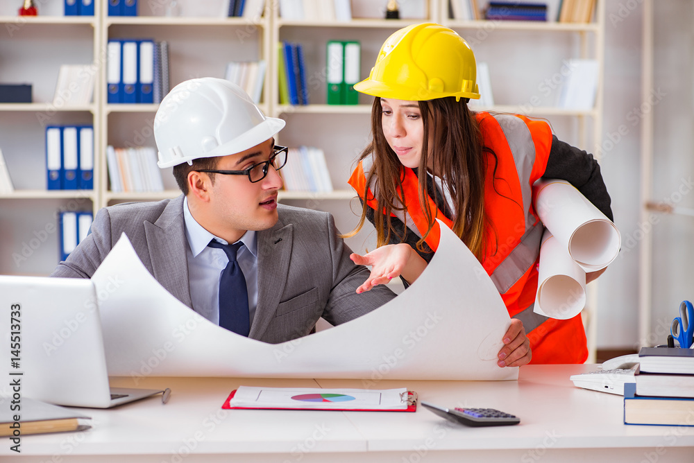 Construction foreman supervisor reviewing drawings Construction foreman supervisor reviewing drawings