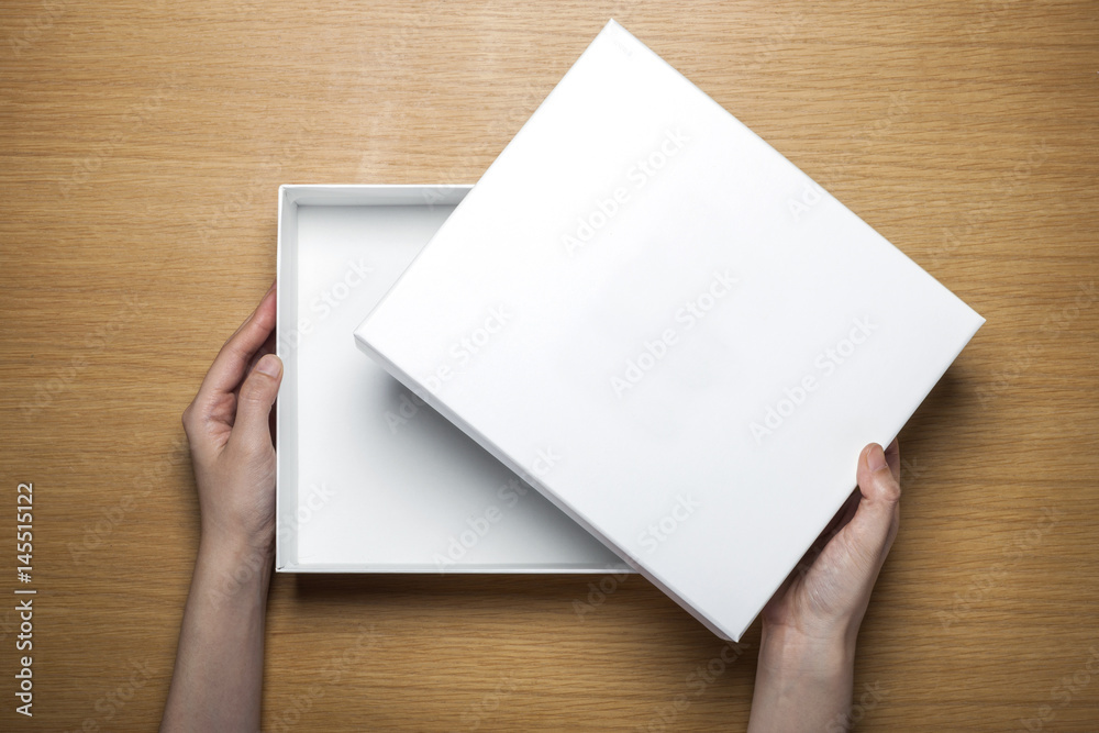 woman hand hold a paper on the wood table(background) woman hand hold a paper on the wood table(background)