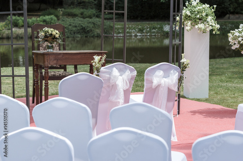 Many wedding chairs with white elegant covers photo