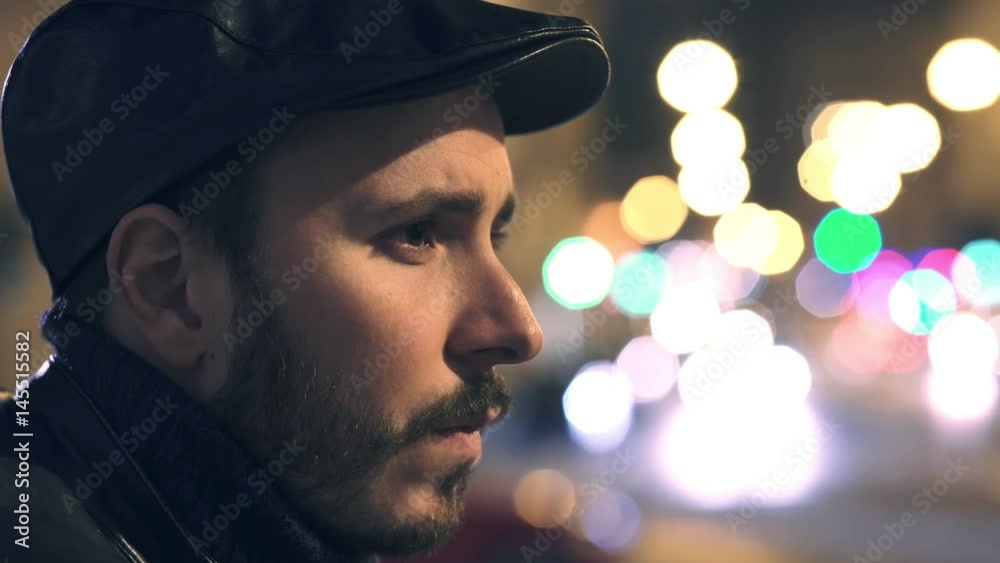 sad and thoughtful man's profile in the city at night sad and thoughtful man's profile in the city at night