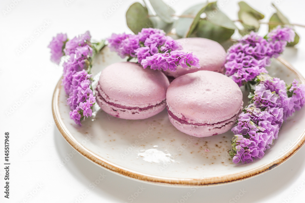 spring woman breakfast with macaroons and mauve flowers white background