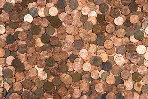 Flat view pennies. United States currency penny, many old new dirty clean viewed from directly above. The penny is the lowest denomination coin in the U.S. currency. photo