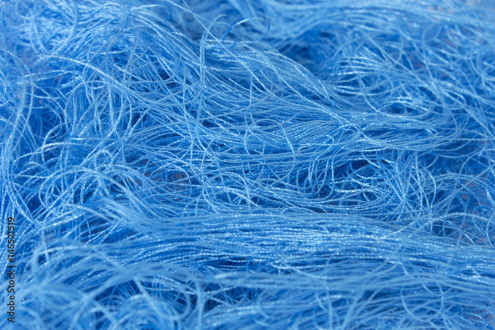 Obraz premium Neon Blue sewing thread roll background