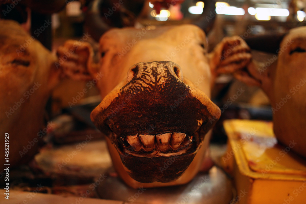 A close up of cow head on a counter at local market for sale. The cow ...