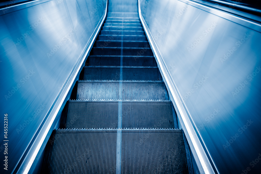 detail shot of escalator in modern buildings or subway station,blue tone. detail shot of escalator in modern buildings or subway station,blue tone.