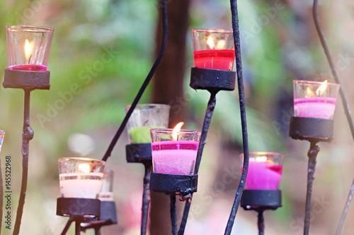Various of colors candles on nature abstract blurry background