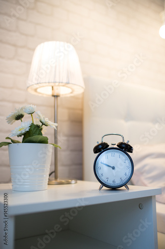 Alarm clock on the bedside table