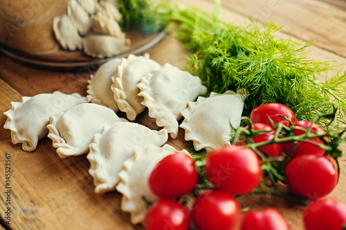 Frozen dumplings with cherry tomatoes and parsley.