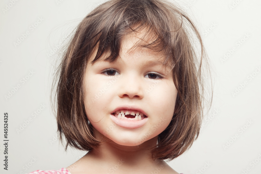 The child dropped the first milk tooth The child dropped the first milk tooth