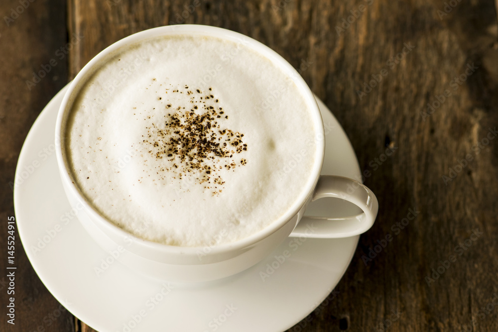 cappuccino coffee in white cup on wooden background cappuccino coffee in white cup on wooden background