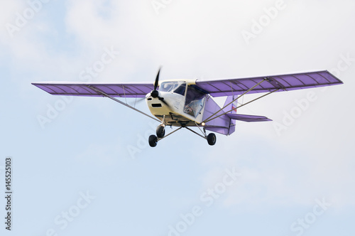 Fototapeta Naklejka Na Ścianę i Meble -  Private propeller-driven airplane flying in cloud sky