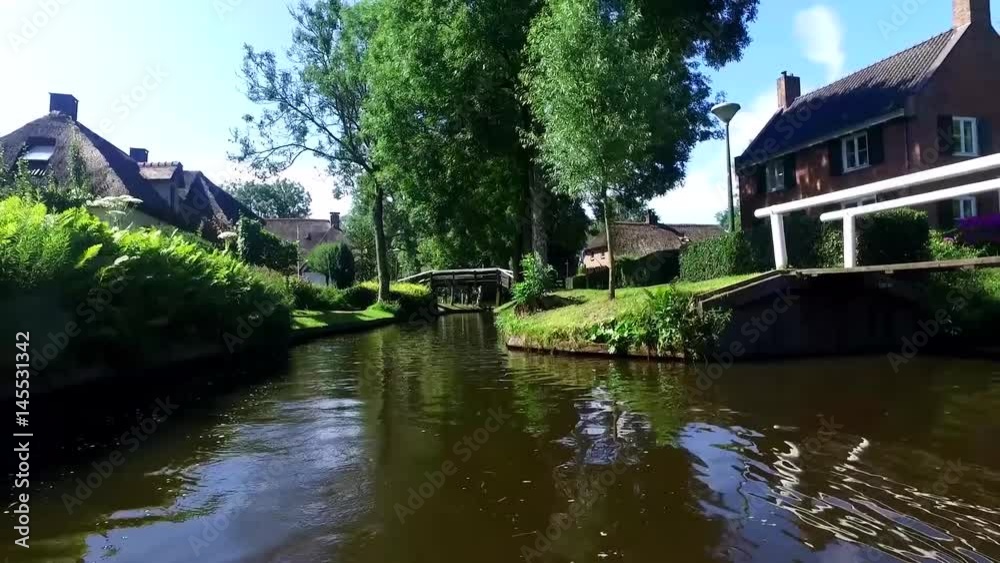 Landscape view of thatched rustic roof houses around canals in famous village Giethoorn. Landscape view of thatched rustic roof houses around canals in famous village Giethoorn.
