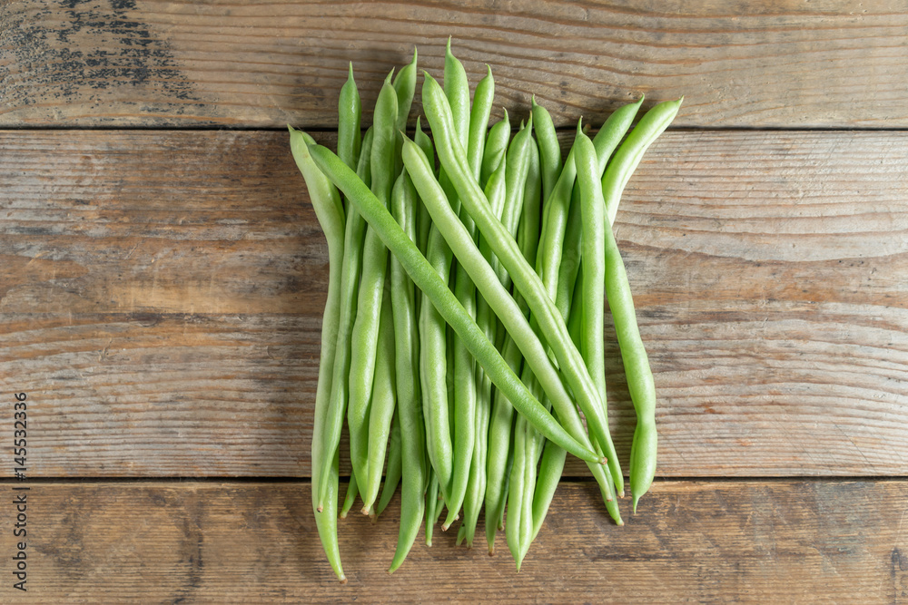 Green bean on wood background. Top view. Green bean on wood background. Top view.