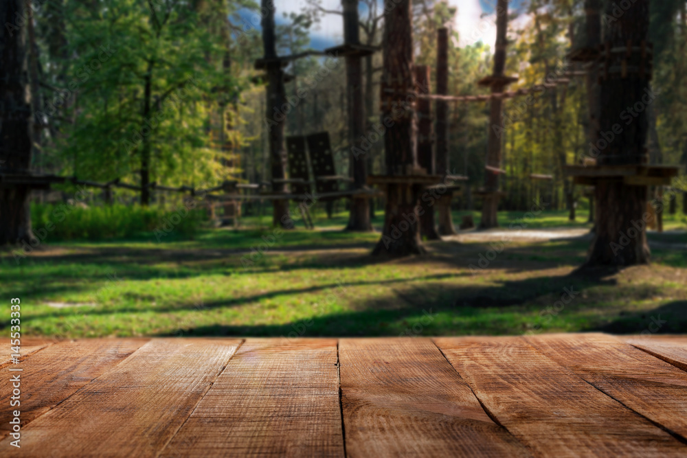 Wooden table on rope park background for product display montage