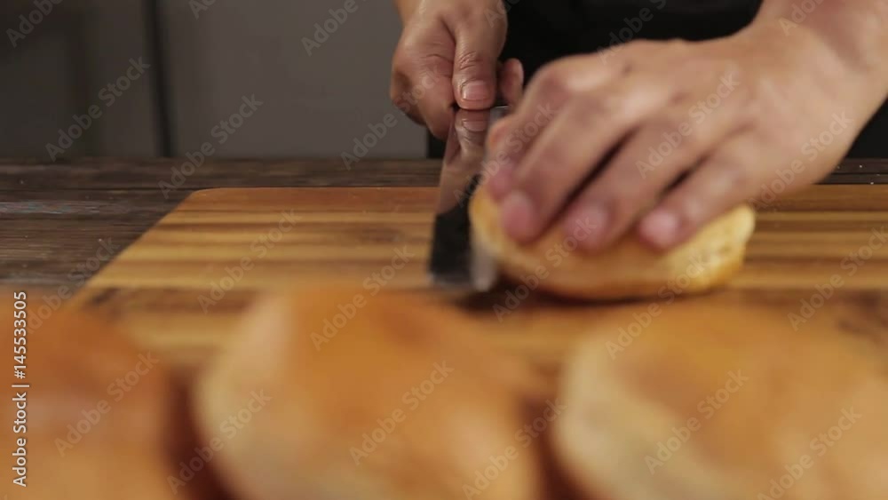 Buns - Cutting Fresh Round Buns On Wooden Table - Front Angle Buns - Cutting Fresh Round Buns On Wooden Table - Front Angle
