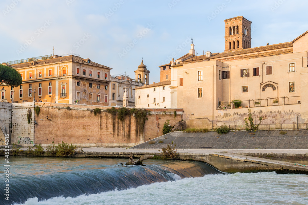 Rome, Italy. The dam on the Tiber and the ancient buildings on the island of Tiberina