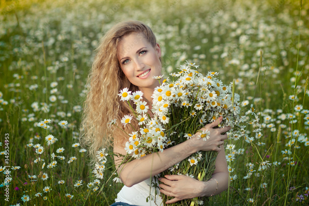 Beautiful lady with cute daughter on camomile field Beautiful lady with cute daughter on camomile field