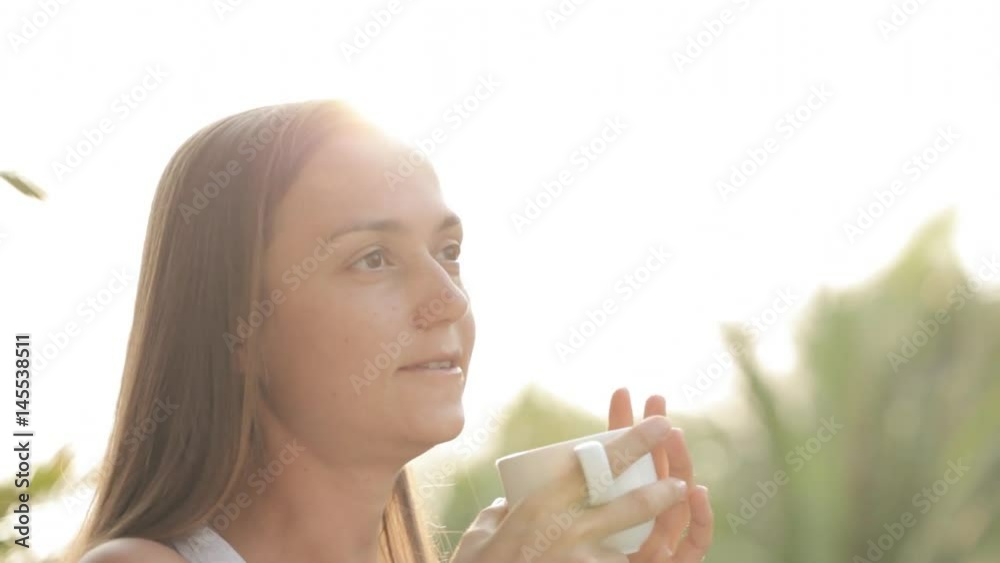 Happy woman drinking coffee in the morning on terrace Happy woman drinking coffee in the morning on terrace