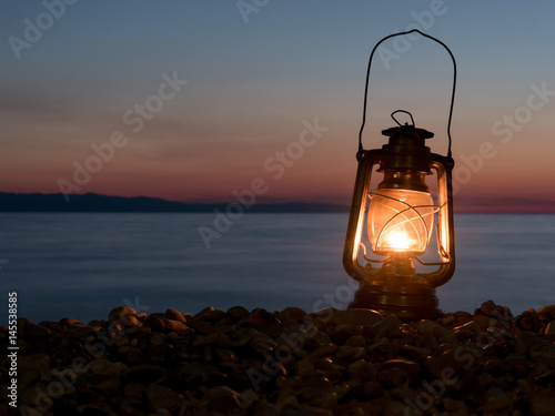 Valokuva Petrol lamp at night on the beach