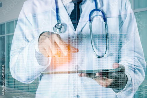 doctor holds laptop with communication technology.