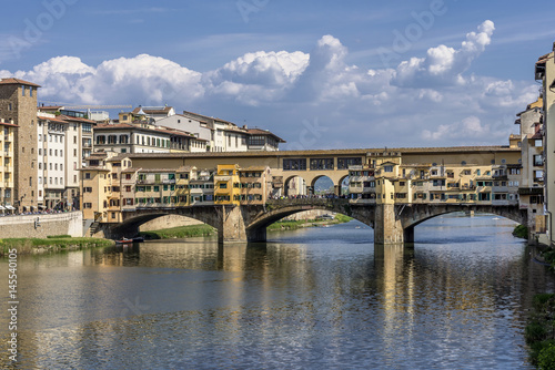 Superb view of the famous Ponte Vecchio bridge from Ponte Santa Trinita, against a picturesque sky, historic center of Florence, Italy