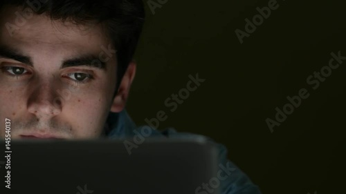 Tired Young Man Working On Laptop Late At Night