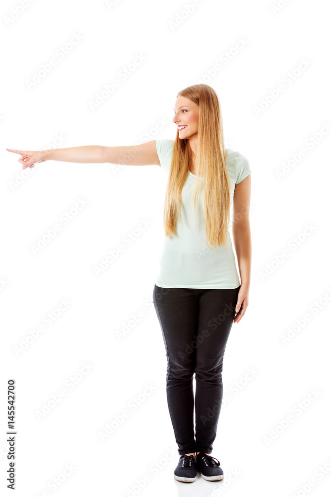Attractive woman looking and pointing sideways. Attractive woman looking and pointing sideways.